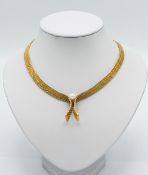 A rolled gold necklace with faux pearl detail, boxed.