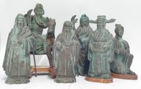 A Chinese bronze collection, to include a pair of bronze lamp bases with wooden stand and