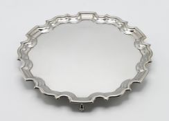 A silver salver, on three scroll feet, hallmarked Sheffield 1995, diameter 25cm, silver weight 17.