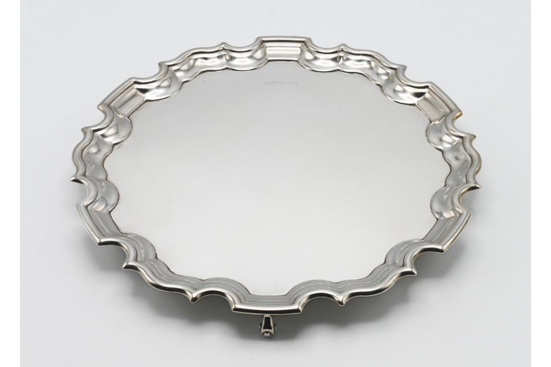 A silver salver, on three scroll feet, hallmarked Sheffield 1995, diameter 25cm, silver weight 17.