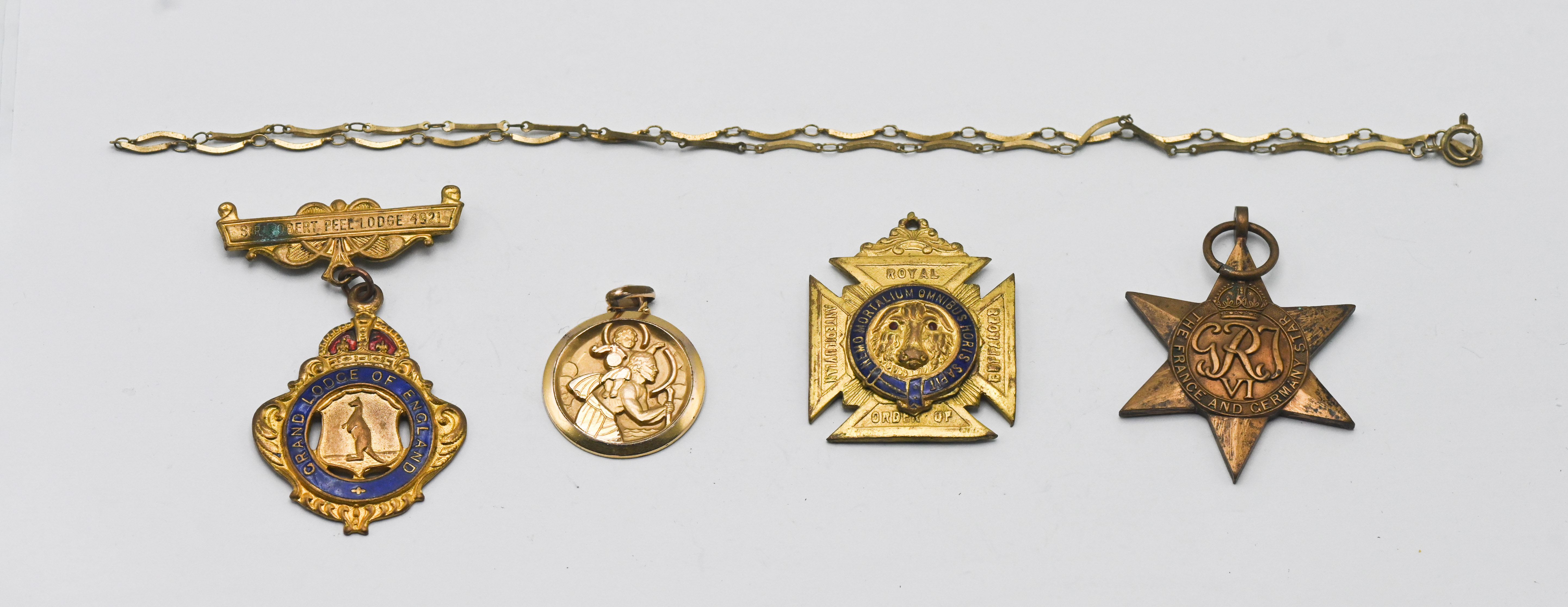A WWI France and Germany Star, together with a St Christopher pendant, a yellow metal chain, and two