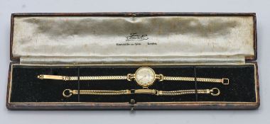 A 9ct gold ladies Vertex watch with spare 9ct gold strap, in case, overall weight 22.68g.