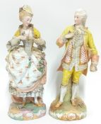 A pair of figures, in Meissen style, depicting a wealthy man and woman in 18th century dress, with