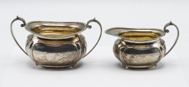 A pair of matching milk jug and sugar bowl, hallmarked Sheffield 1909, maker GH Harrison