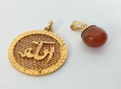 Two Iranian? Gold pendants, marked '750', one with a red stone, total weight 9.1g. (2)