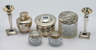A pair of silver candlesticks, hallmarked Sheffield 1913, together with three white metal lidded