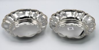 A pair of large modern silver bowls, hallmarked Birmingham 1987, and Birmingham 1972, total silver