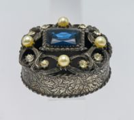 An ornate white metal jewel box, with pierced lid and engraved foliate design, lid encrusted with