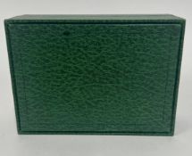 A Rolex green watch box.