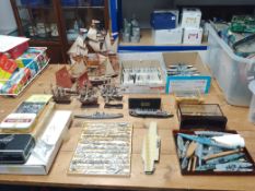 A collection of 14 wooden model ships, a box of Triang United Kingdom and German WWII model