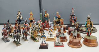 Military busts and models on plinths, in addition to diecast mounted soldiers in a