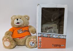 An iTeddy, in an orange shirt, boxed, the toys offers MP4 video play and audio story-telling