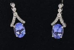 A pair of 14ct white gold diamond and tanzanite earrings.