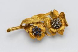A good 18ct yellow gold sapphire and diamond flower brooch, marked 750, approx 14.84g