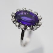 A 18ct white gold diamond and large amethyst set cluster ring, size J/K.