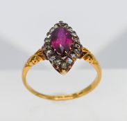 An 18ct yellow gold marquise shape ruby and diamond ring, size N.