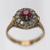 A ruby and diamond cluster ring, set in yellow gold, stamped 18k, size L/M.
