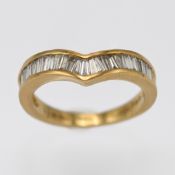 An 18ct yellow gold and baguette cut diamond wishbone ring, marked 1.00 inside, size O.