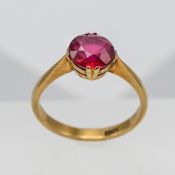 An 18ct yellow gold ring set with red stone, approx 3.4g