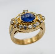 An 18ct yellow gold diamond and sapphire cabochon ring, approx 10.4g, size O