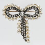 A double row bow shape diamond and pearl set brooch, gold and silver fronted set, with mixed old