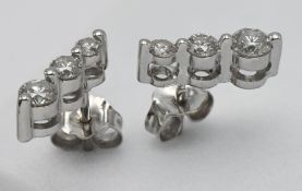 A pair of 18ct white gold and diamond three stone drop earrings.