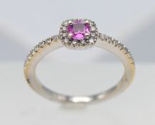 An 18ct white gold diamond and pink sapphire ring, size L.