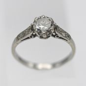 A platinum diamond solitaire ring set with further diamonds to the shoulders, very approx 0.75ct
