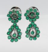 A pair of emerald set cluster earrings, with screw fittings (not hallmarked), approx 8.7g