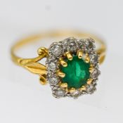 An emerald and diamond cluster ring, set in yellow gold, size P, hallmark rubbed.