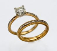 A 9ct gold diamond solitaire with further diamonds to the shoulders, size J together with a matching