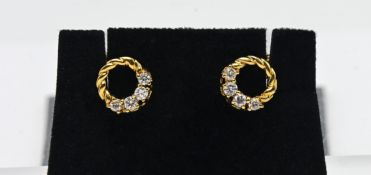 A pair of 18ct yellow gold diamond circular stud earrings.