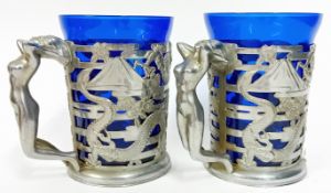 A pair of silver plated and blue glass tankards, with pierced Chinese foliate, pagoda and dragon