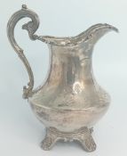 An elaborate Victorian silver jug, with florid engraving and embossed rim, hallmarked London 1841,
