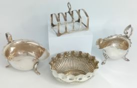 Two 20th century silver jugs, together with a toast rack and a white metal bowl by Elkington and