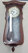 A 20th century Kieninger wall clock, dark wood, roman enamel dial, height 61cm.