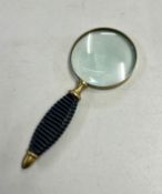 A magnifying glass with black hardstone handle.