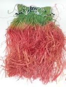 A coloured grass skirt circa 1940s from the south Pacific, beaded decoration and plaited