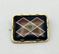 A Scottish brooch decorated with onyx and semi precious stones.