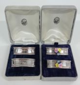A pair of silver oblong napkin rings, boxed, hallmarked London 1987, together with another with