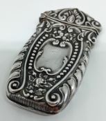 A silver vesta case, with embossed foliate design, marked 'STERLING G', hinged opening, with