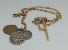 An 18ct gold watch chain, with three religious coin pendants, total weight 28.8g.
