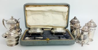 A pair of silver and blue glass mustard pots and one spoon, cased (one spoon missing), hallmarked