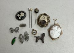 A mixed collection including a 9ct gold cameo brooch, two marquisette brooches, three hat pins, a