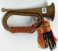 A brass Royal Artillery bugle, with red yellow and black bugle knot, length 27.5cm. Sold on behalf