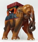 A hand carved wooden elephant plinth, painted decoration, height 31cm, length approx 32cm. Sold on