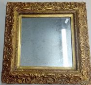 A pair of square mirrors in ornate gilt frames, overall size 40cm x 40cm.