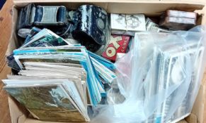 A quantity of early 20th century postcards, cigarette cards, cased spectacles, and a motorbike