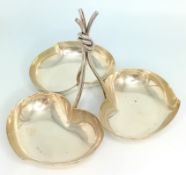 A silver triple bonbon dish, leaf designed bowls and drawn up twisted stem, stamped 925, silver