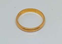 A 22ct gold wedding band, weight 4.5g.